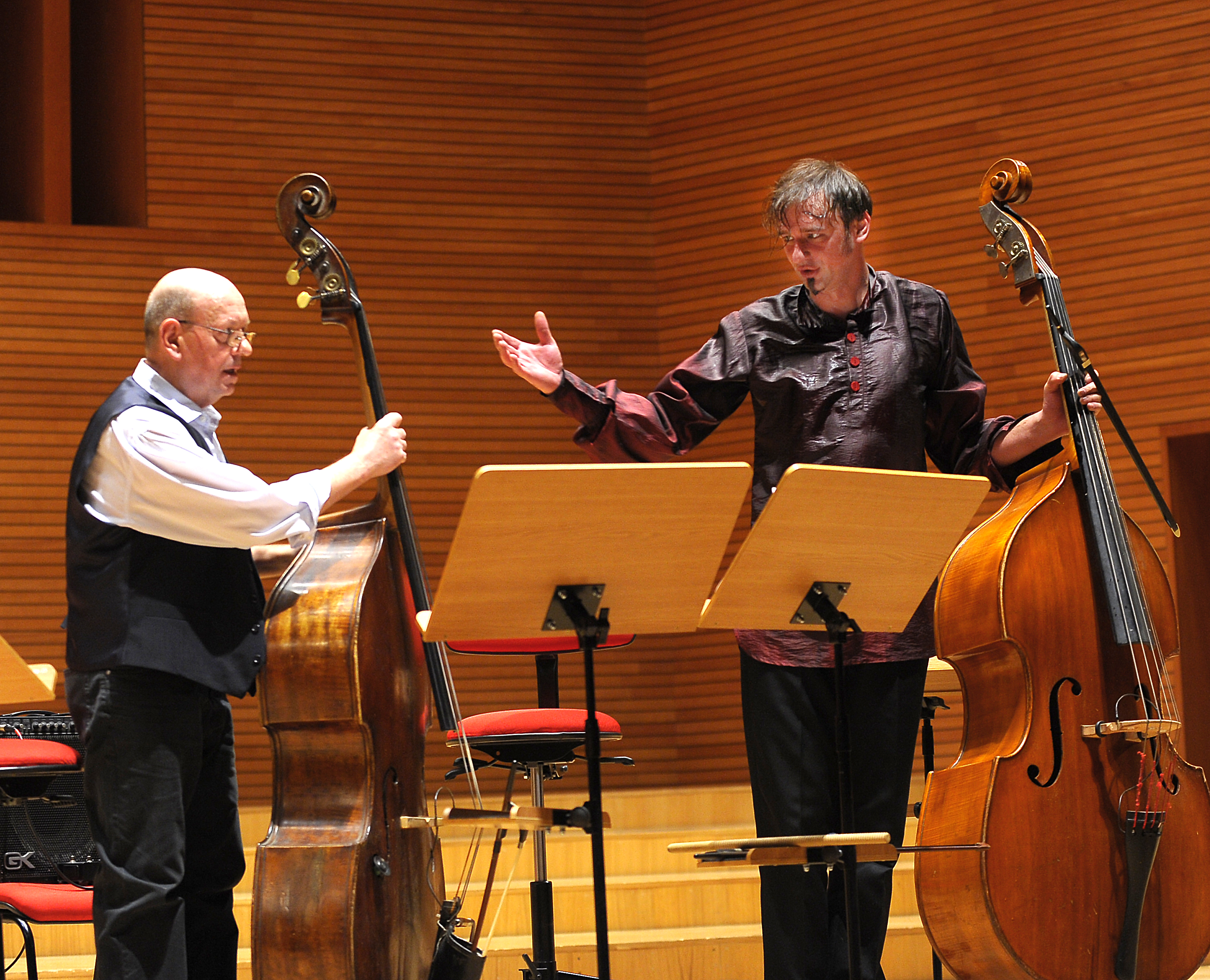 Zbigniew Wegehaupt playing double bass as Aleksander Gabryś gestures towards him during the performance.